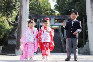 神社で七五三のお参りをする子供たち